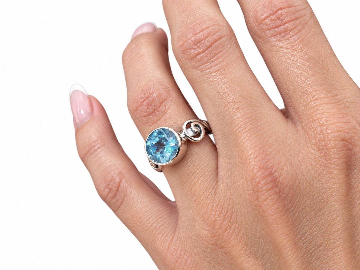 Silver Swirl Ring with Large Bezel Set Blue Topaz