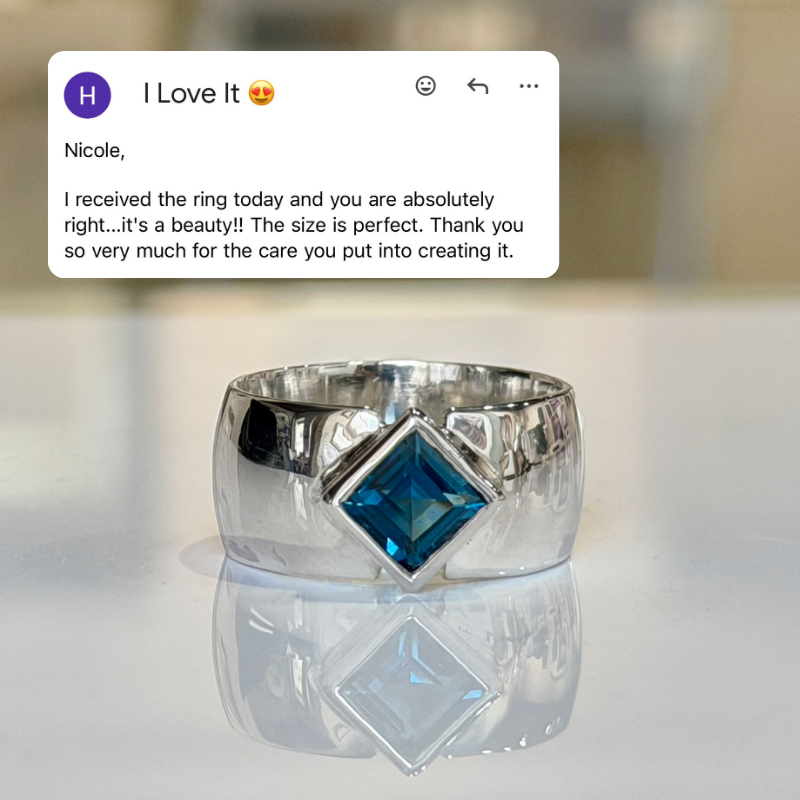 A polished silver ring with a large diamond-cut blue gemstone, displayed on a reflective white surface with a blurred background. A customer review card is overlaid at the top of the image.