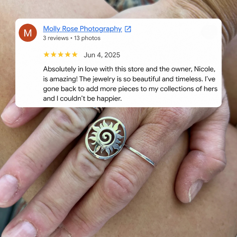 A close-up of a person's hand wearing a silver ring with a sunburst spiral design, with a Google review overlay from Molly Rose Photography.